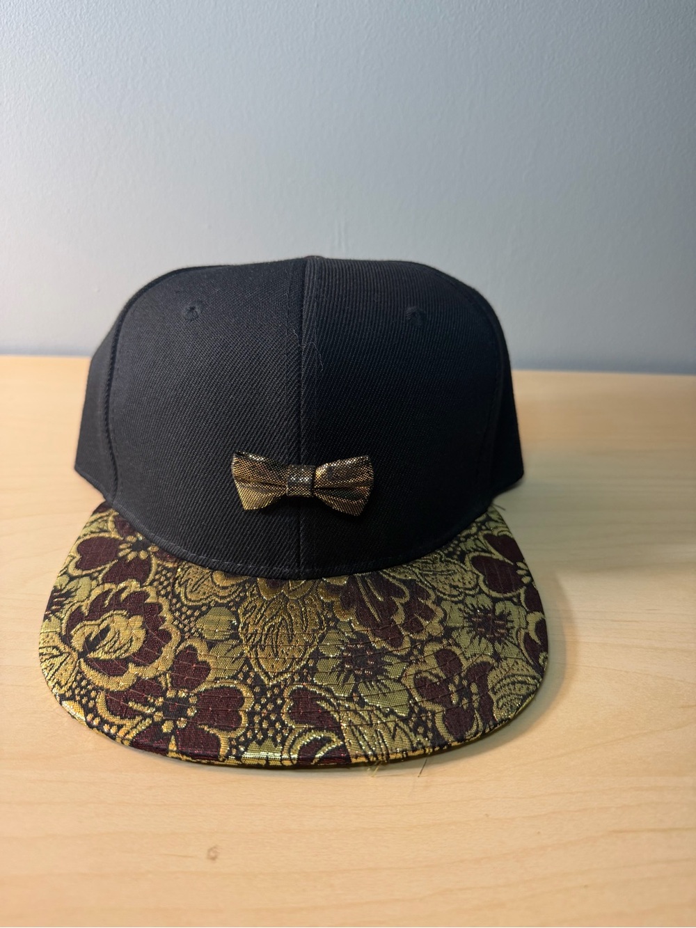 Black Snapback Hat with Gold Bow and Floral Brim